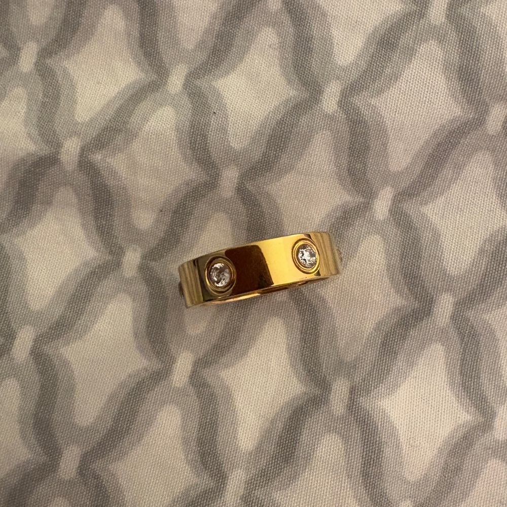 Gold dipped Ring over stainless steel with cubic zirconia.